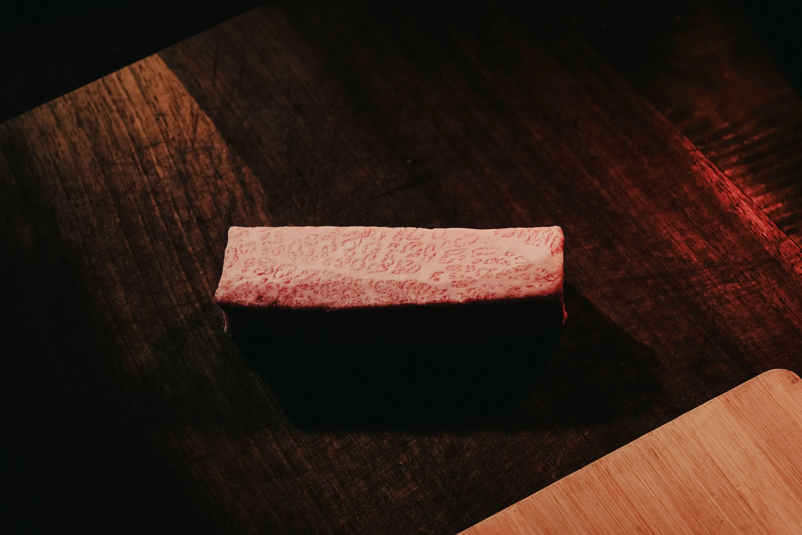 Marbled wagyu on a dark wooden board